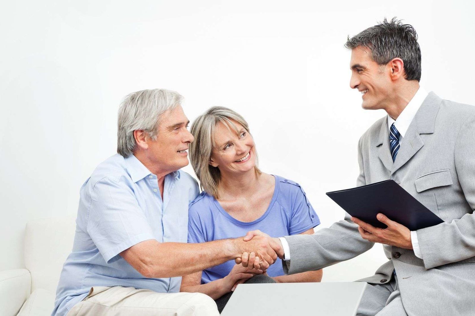 man shaking couples hands