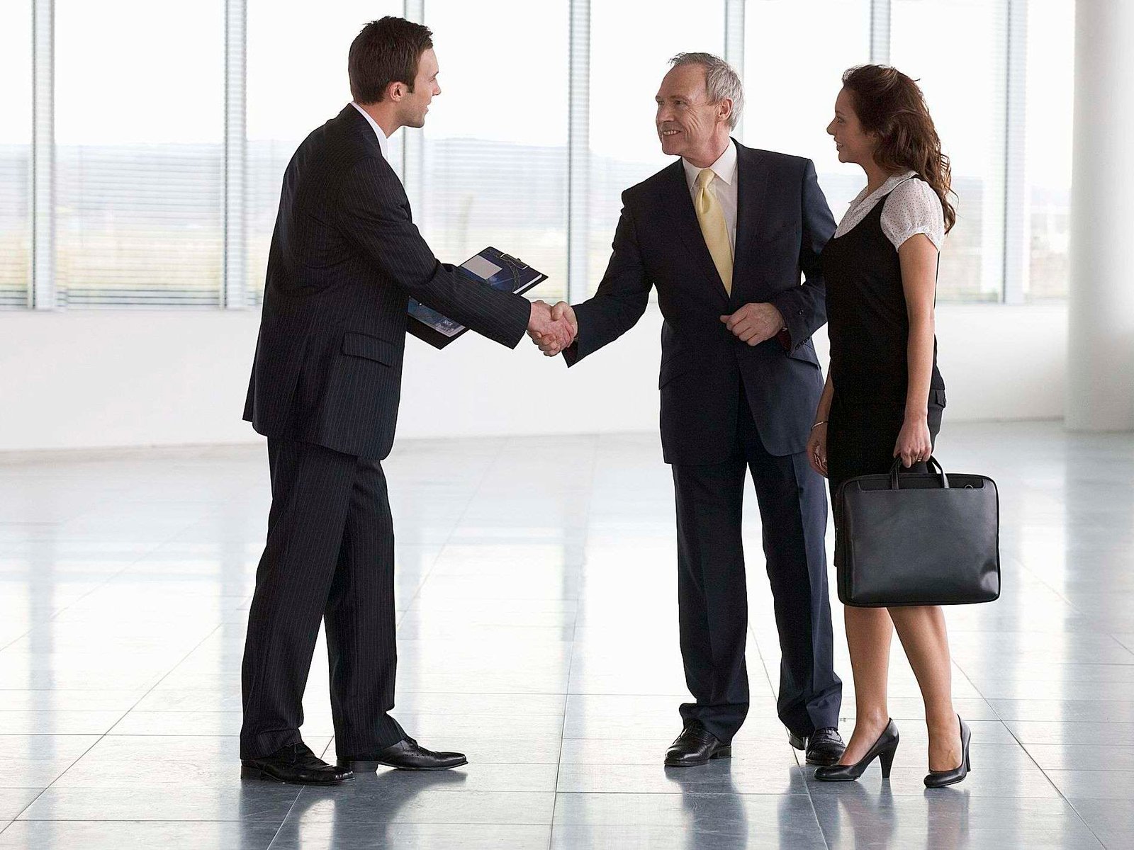 commercial property agent greeting business man and business woman