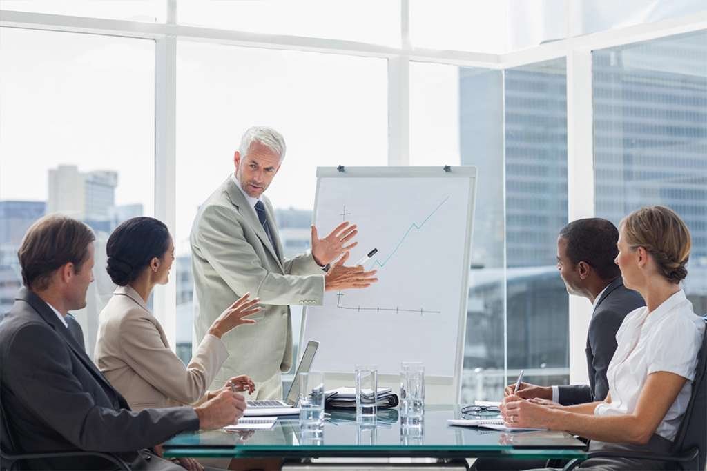 5 people in a commercial real estate strategy meeting about the economy